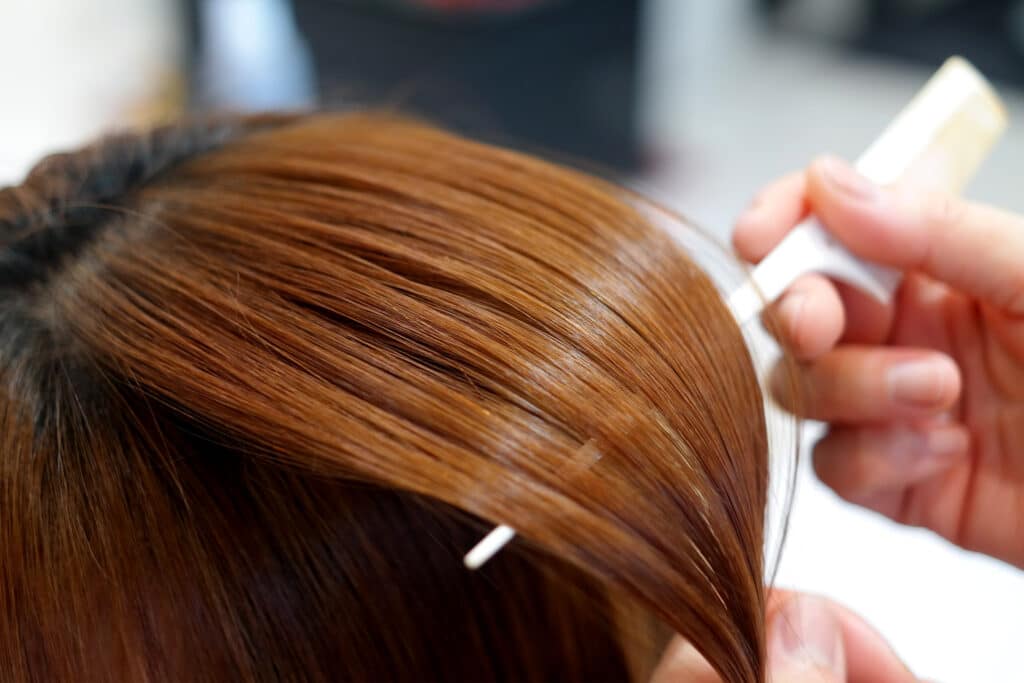 A woman receiving hair relaxer or hair straightener treatment, now the subject of a lawsuit Carter Mario Law Firm is pursuing.