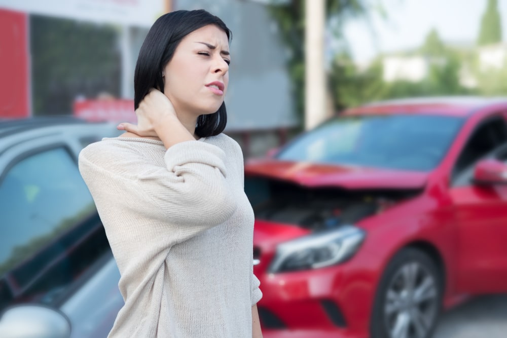 A woman suffering a neck injury after a car accident